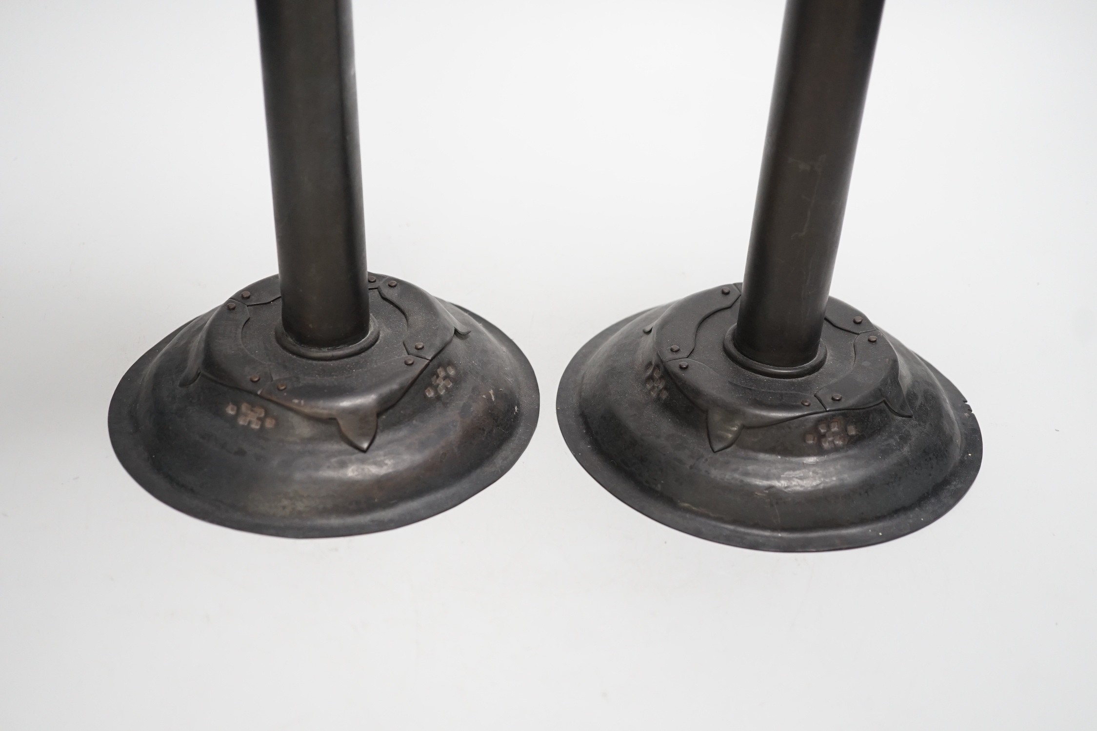 Attributed to Glasgow School of Art - a pair of Arts and Crafts pricket candlesticks. 40cm tall